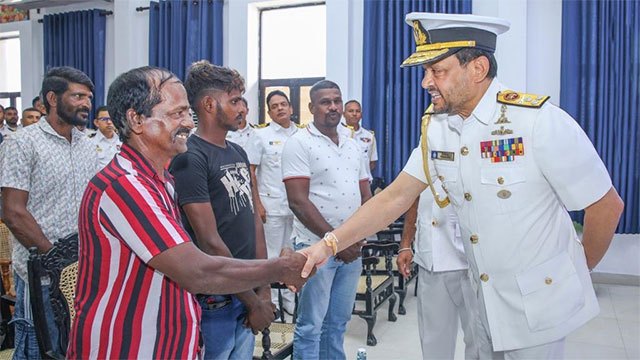 Sri Lanka Navy officials presenting letters of appreciation to 14 Angulana residents for their role in a life-saving rescue